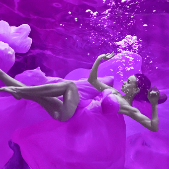 Peitho-Perfumes.ScentedCandles_ A Swiss woman in a handmade purple dress, floating in the water.