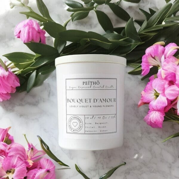 Peitho-Perfumes.ScentedCandles_ A Swiss molecular perfume surrounded by pink flowers.