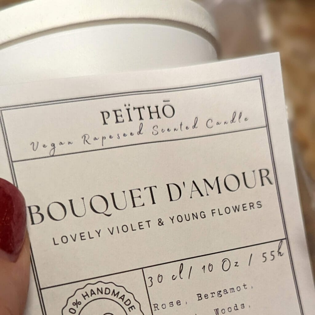 Peitho-Perfumes.ScentedCandles_ A homemade Swiss coffee with a label that says bouquet damour. (Keywords: homemade, Swiss)