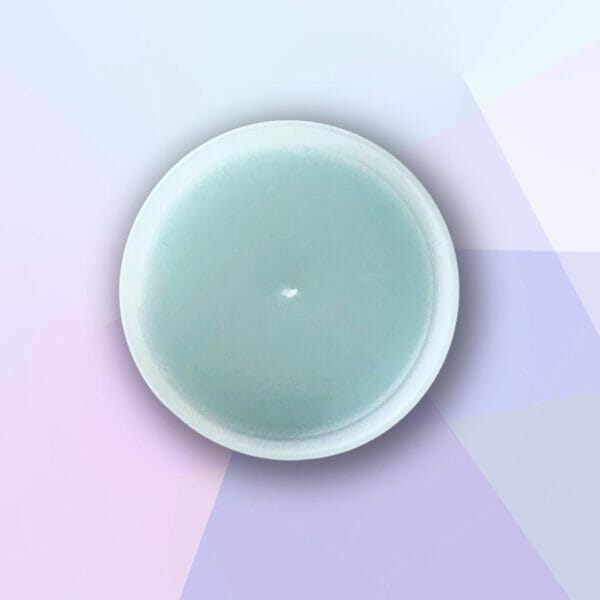 Peitho-Perfumes.ScentedCandles_ A homemade scented candle with a Sunny Lakeside aroma on a purple background.