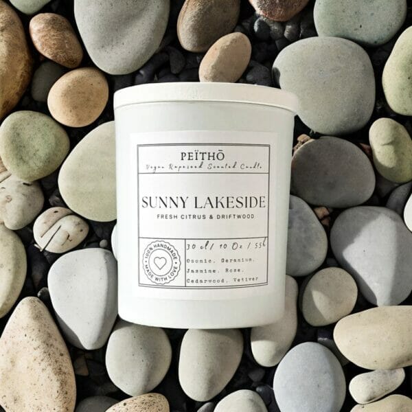 Peitho-Perfumes.ScentedCandles_ A homemade scented candle with a Sunny Lakeside aroma placed on rocks.