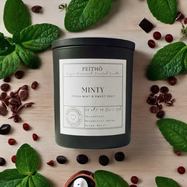 Peitho-Perfumes.ScentedCandles_ black candle jar called minty on wooden table with chocolate and peppermint