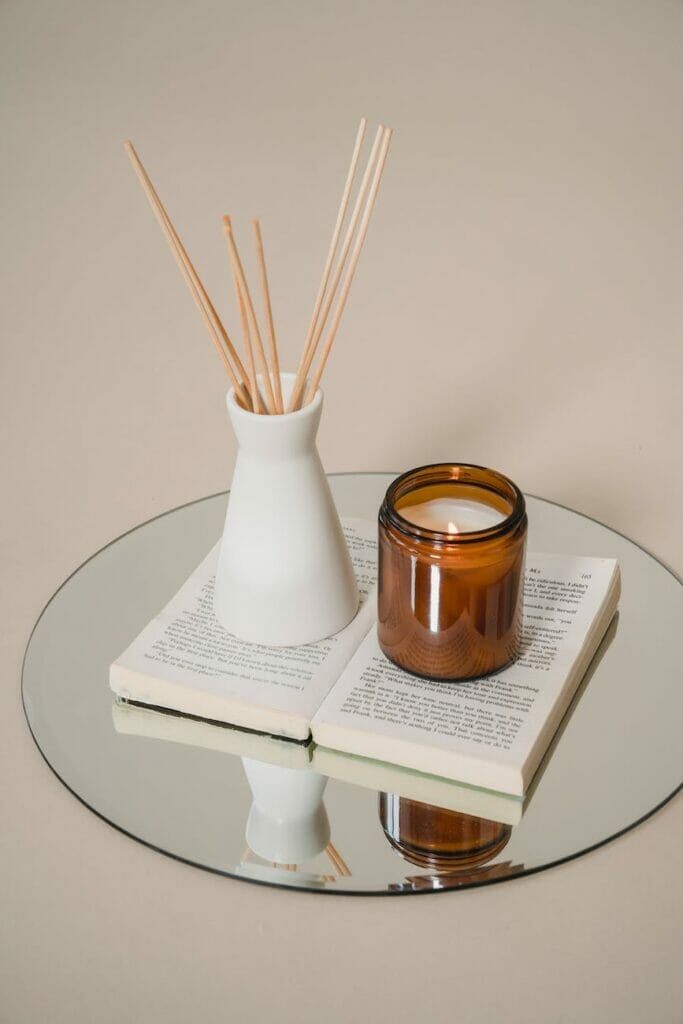 amber candle on adn open book