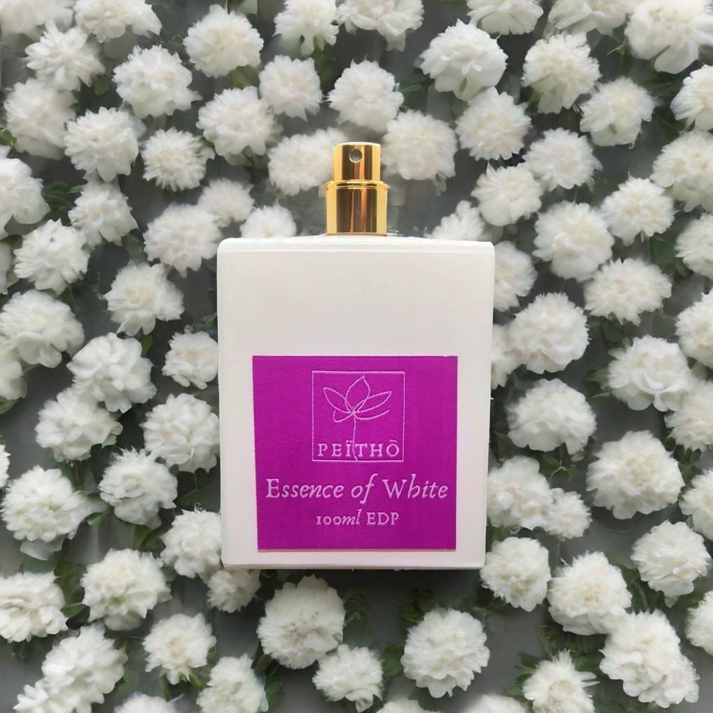 Peitho-Perfumes.ScentedCandles_ The Essence of White - Eau de Parfum 100ml surrounded by white flowers.